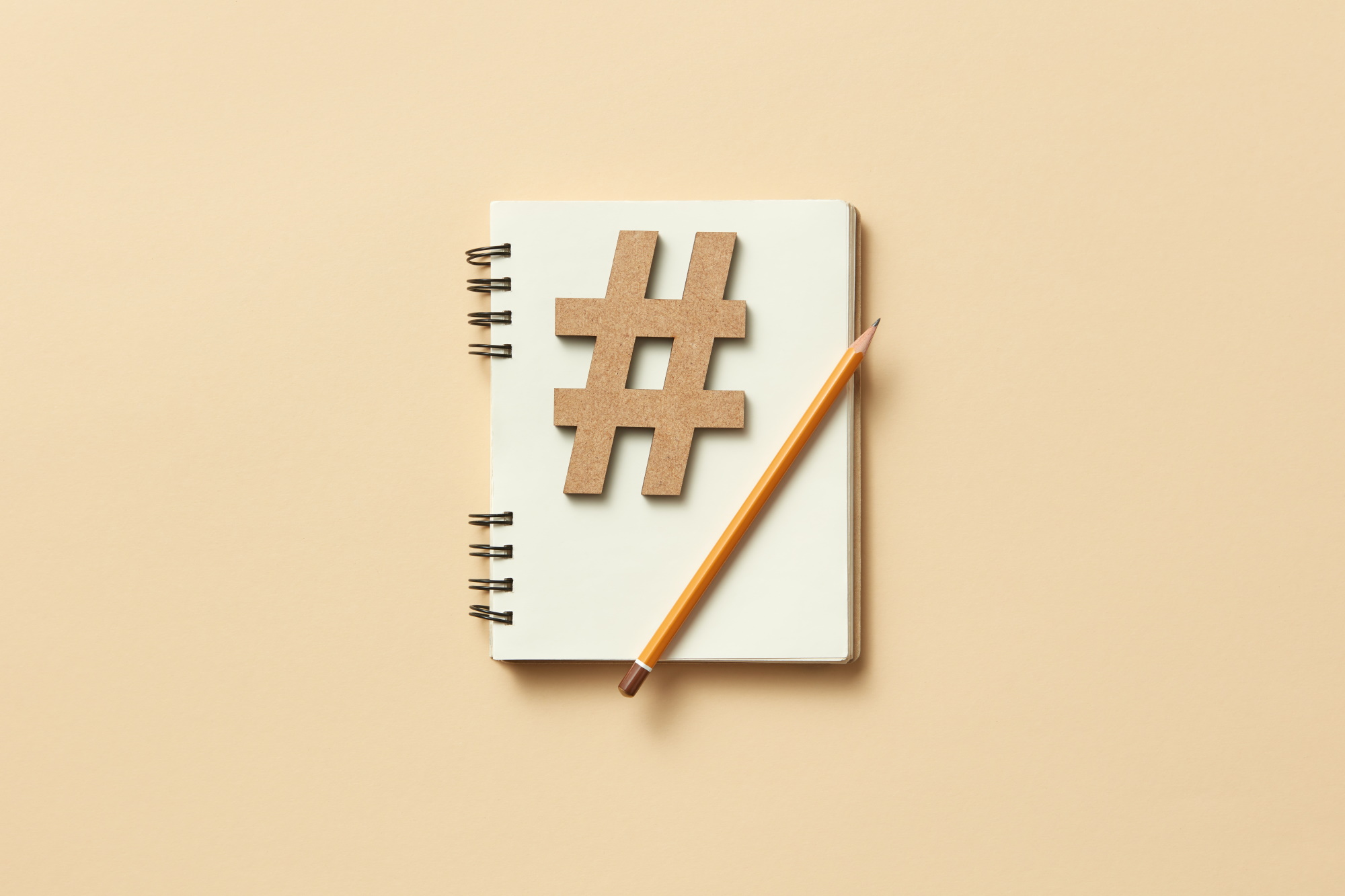 hashtag on notebook with pencil on top