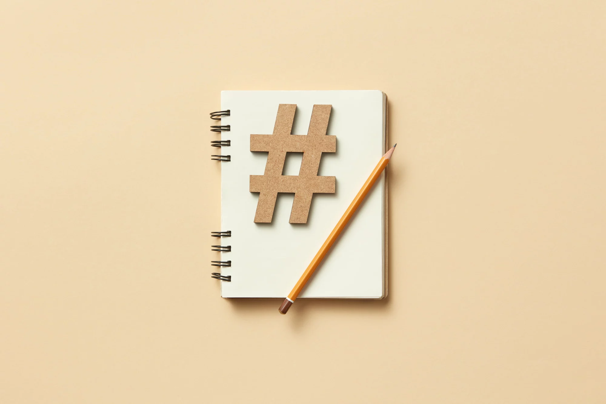hashtag on notebook with pencil on top