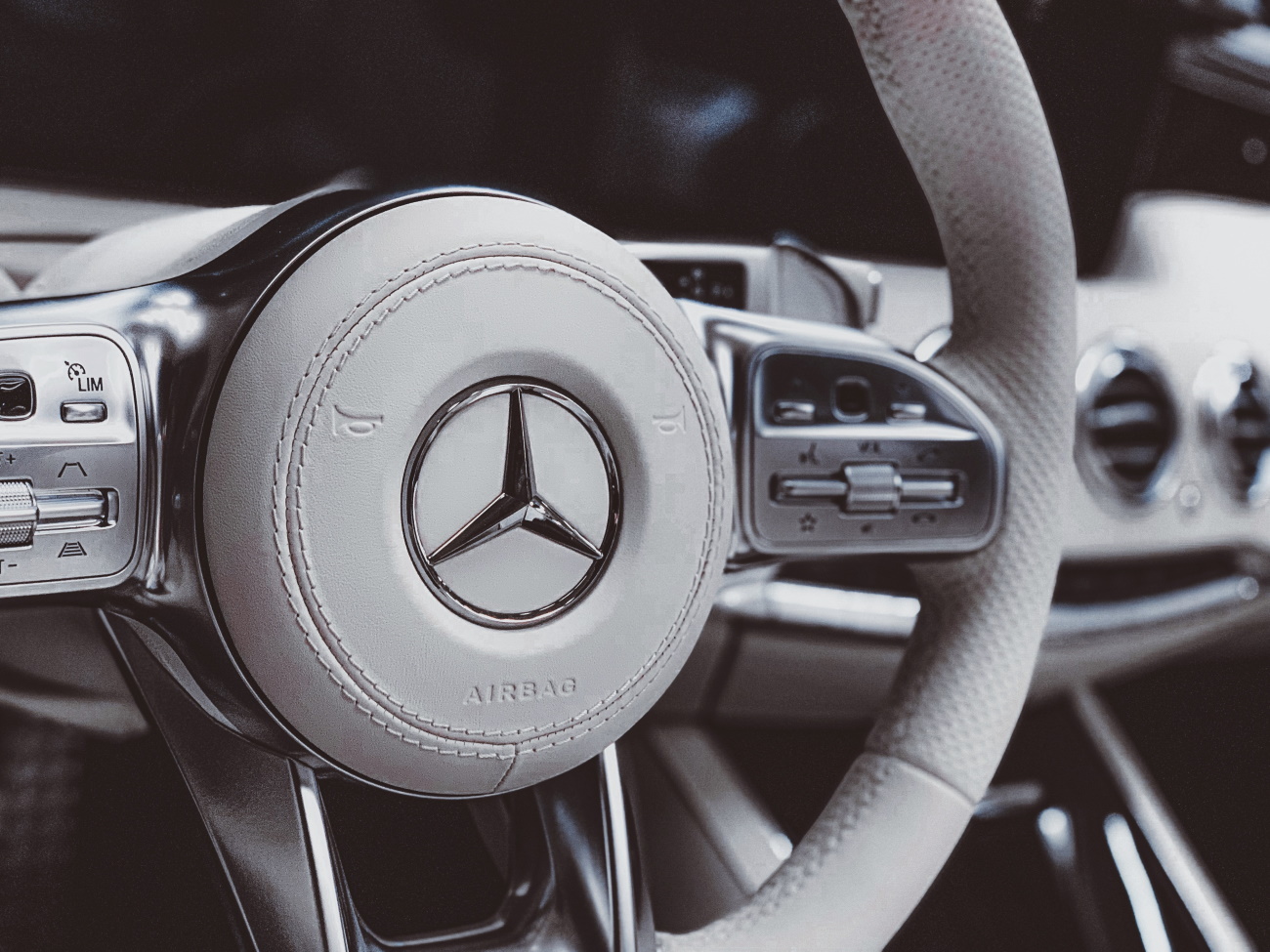 close up of steering wheel with Mercedes Benz emblem