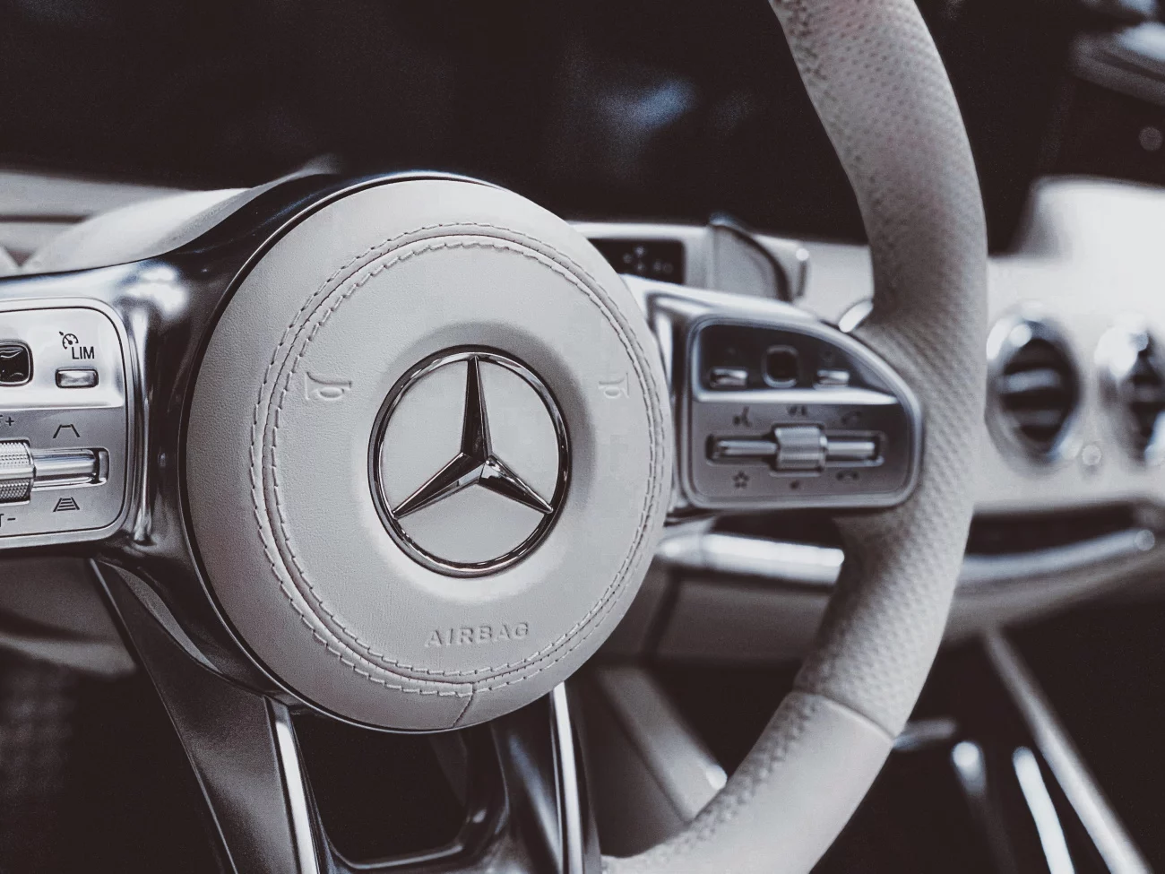 close up of steering wheel with Mercedes Benz emblem