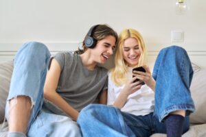 Couple of teenagers looking into the smartphone